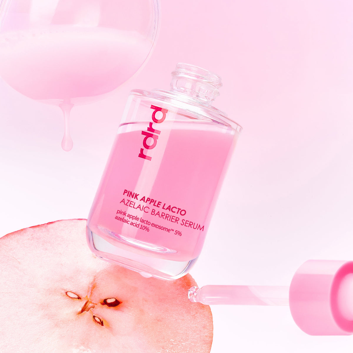 rdrd PINK Apple Lacto Azelaic Barrier Serum – open bottle with sliced apple